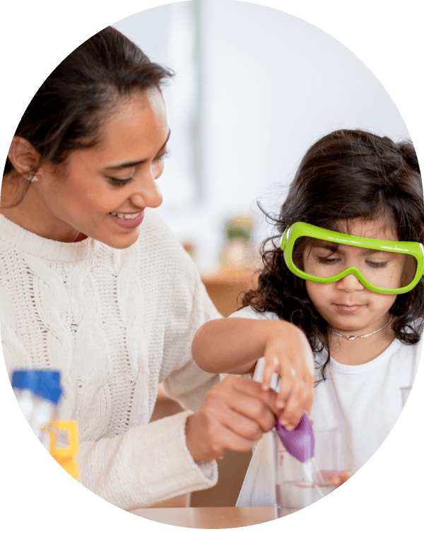 Child learning STEAM science activity with teacher