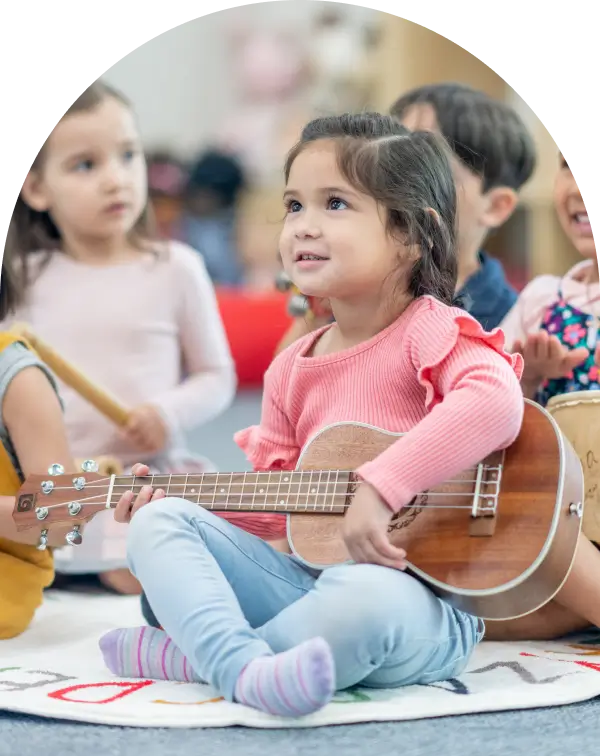 Child learning how to play the guitar