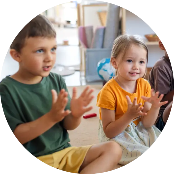 Happy children in backup child-care clapping